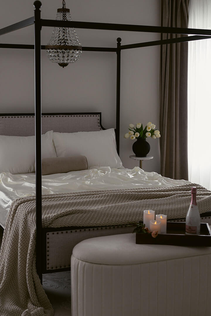Boudoir studio interior with bed, candles and champagne