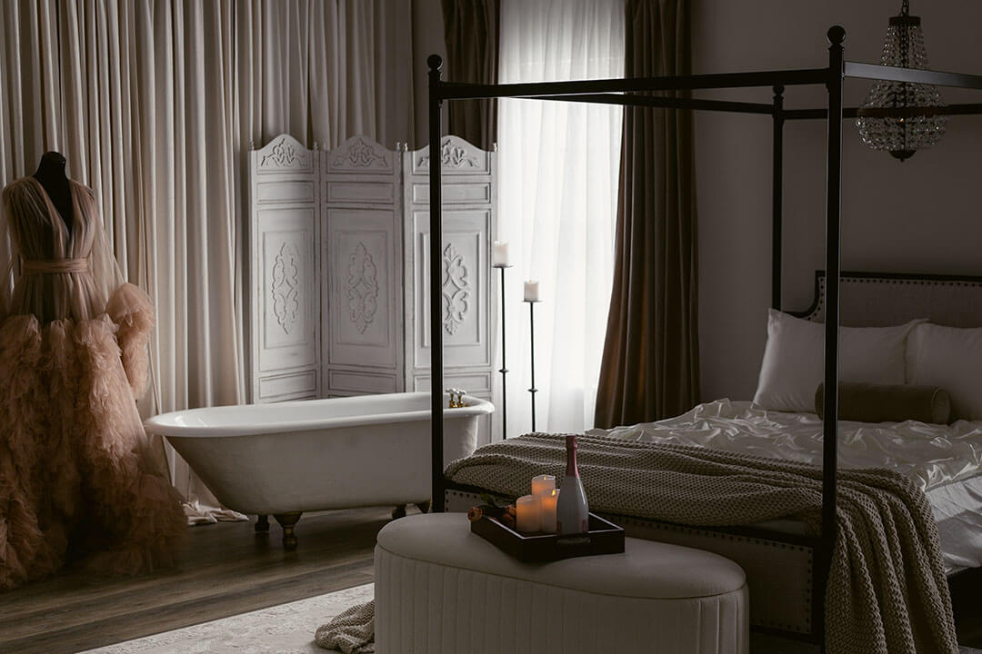 boudoir studio interior of bed and tub and gown